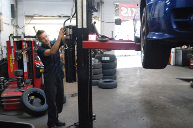 mechanic raising a car in a garage