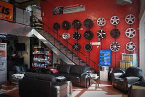 waiting area with couches and wheels displayed on wall